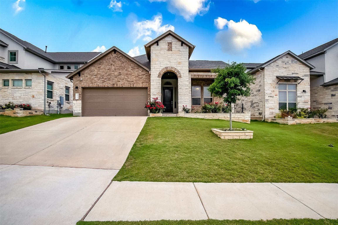 a front view of a house with a yard