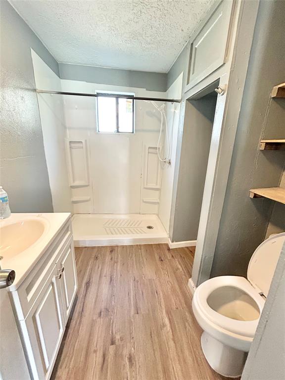 602 Ella Street Dublin, TX 76446 - Photo 4 of 13 a bathroom with a granite countertop sink toilet and shower