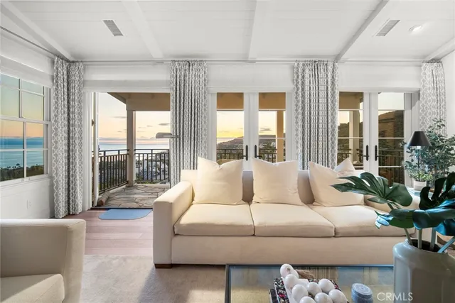 a kitchen with stainless steel appliances a stove a white cabinets and a wooden floor