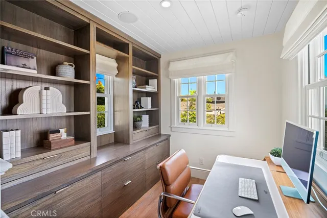 a living room with fireplace furniture and a large window