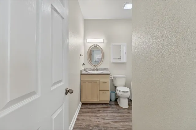 a bathroom with a toilet a sink and a mirror