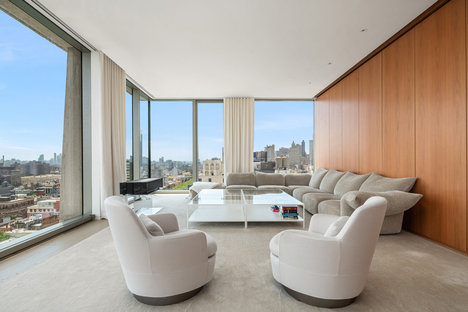 215 Chrystie Street, Unit 27E Manhattan, NY 10002 - Photo 1 of 1 a living room with furniture and large windows