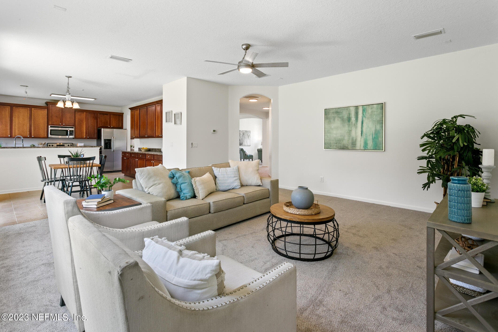 9188 Raptor Drive Jacksonville, FL 32221 - Photo 17 of 36 a living room with furniture a chandelier and a dining room