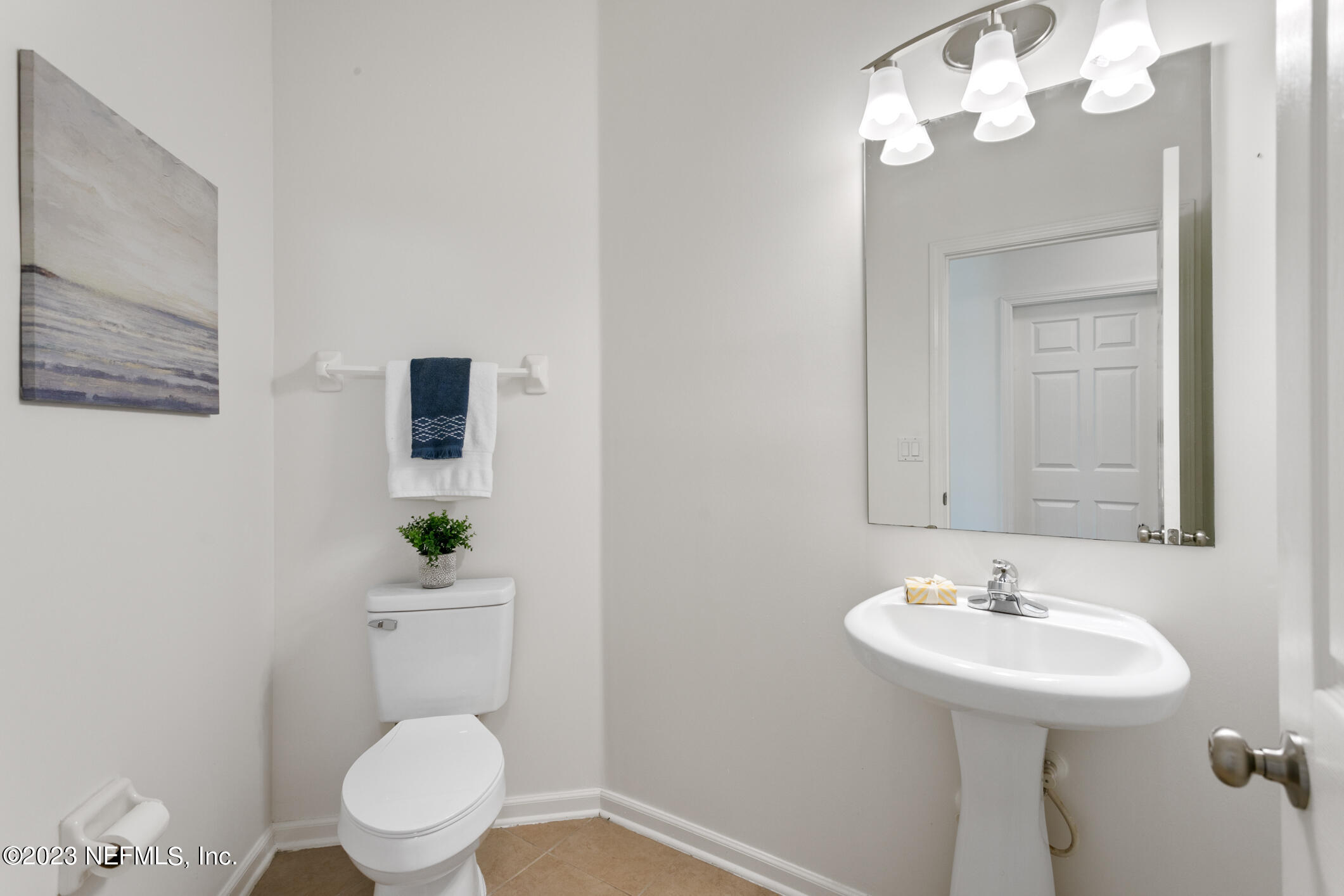 9188 Raptor Drive Jacksonville, FL 32221 - Photo 18 of 36 a bathroom with a toilet sink and mirror