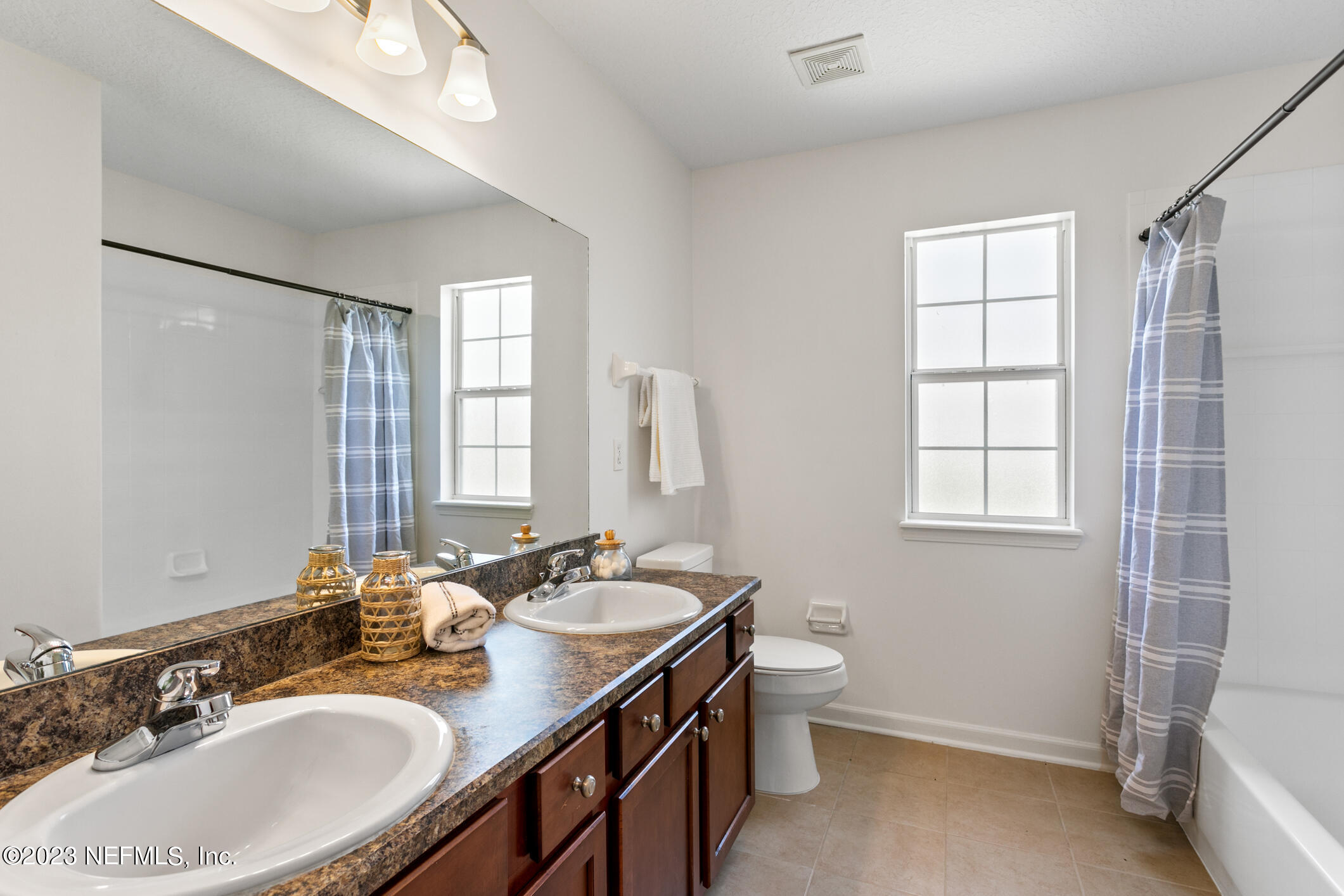 9188 Raptor Drive Jacksonville, FL 32221 - Photo 20 of 36 a bathroom with a sink double vanity granite and a toilet