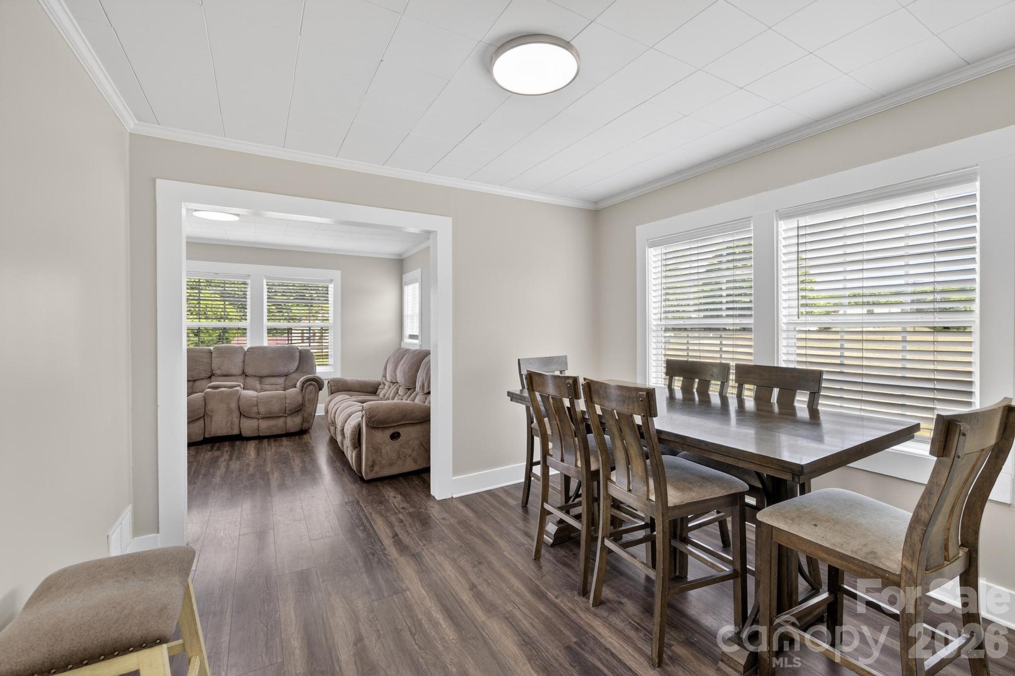 2076 Connelly Springs Road Lenoir, NC 28645 - Photo 10 of 47 a view of a dining room with furniture and wooden floor