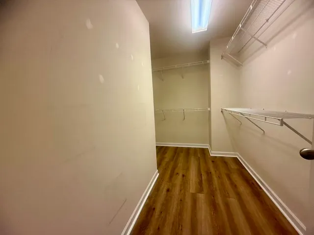 a view of a room with wooden floor and door