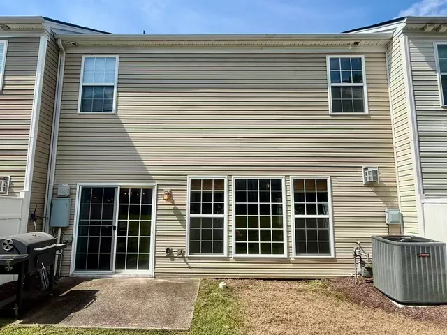 a front view of a house with large windows