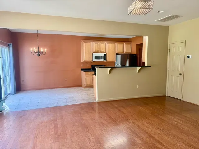 a view of a room with wooden floor