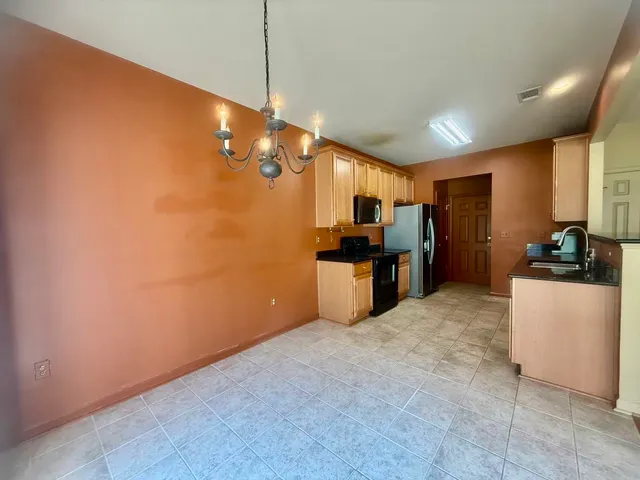 a large kitchen with cabinets and stainless steel appliances