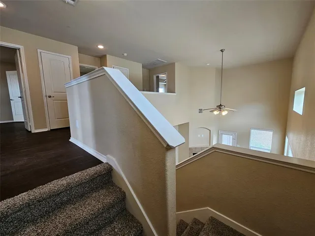a view of a hallway with stairs