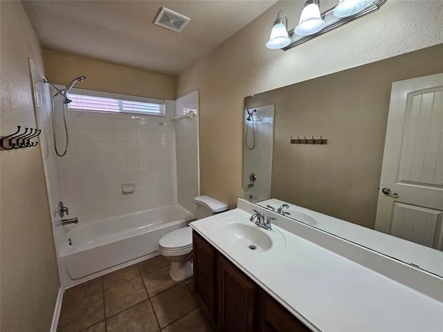 a bathroom with a double vanity sink toilet mirror and shower