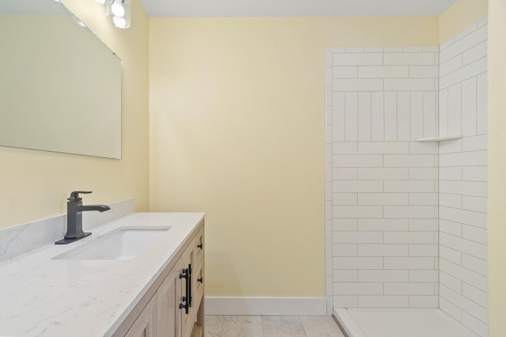 120 Townsend Street, Unit 1 Pepperell, MA 01463 - Photo 18 of 25 a bathroom with a sink and a mirror