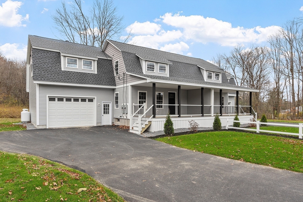 120 Townsend Street, Unit 1 Pepperell, MA 01463 - Photo 21 of 25 a front view of a house with a yard and porch