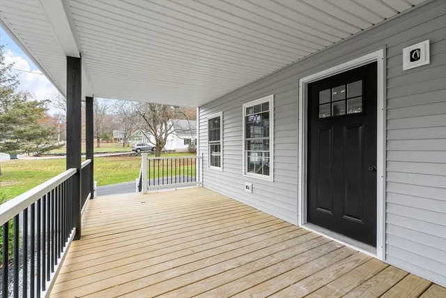 a view of a balcony with wooden floor
