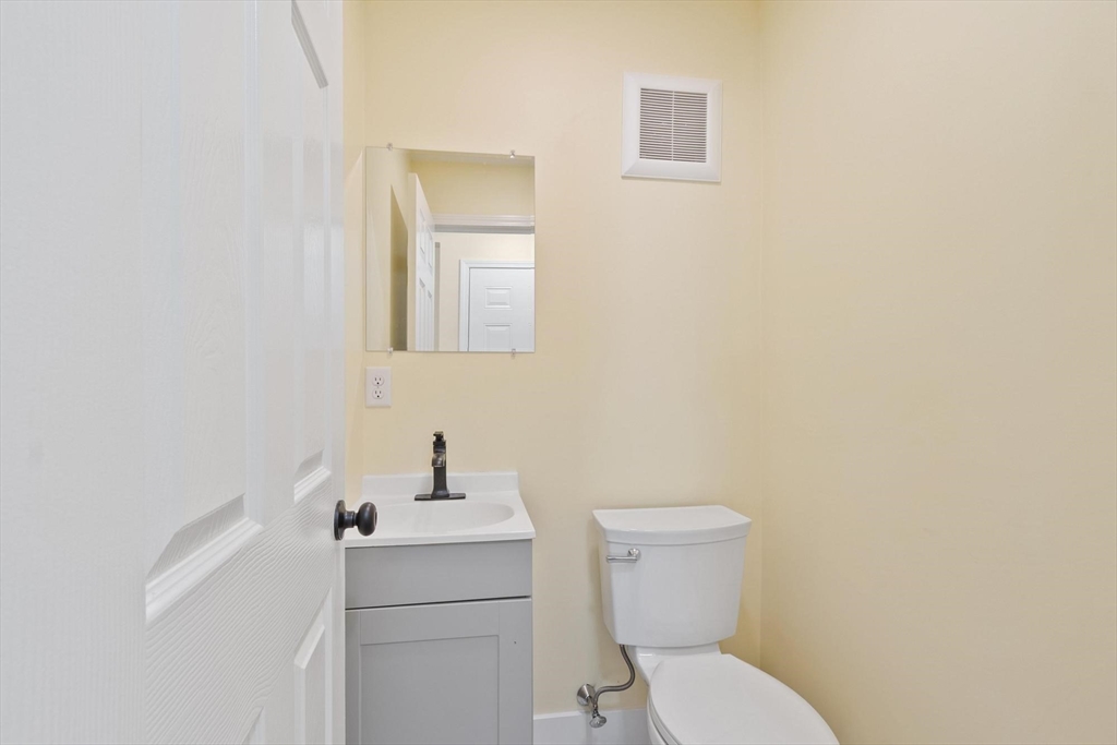 120 Townsend Street, Unit 1 Pepperell, MA 01463 - Photo 9 of 25 a bathroom with a toilet sink and mirror