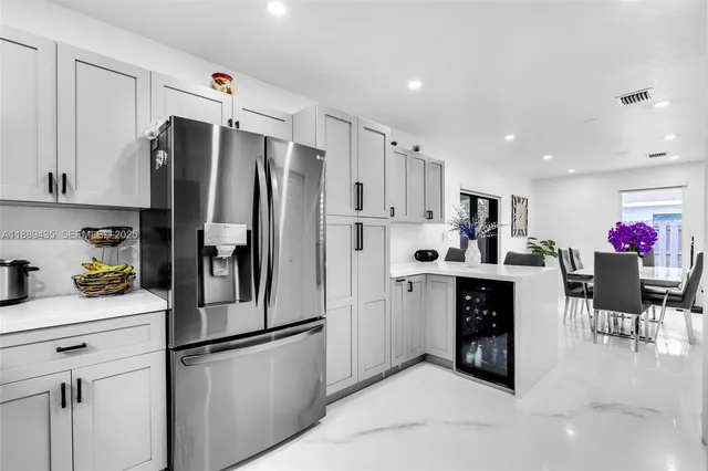 a kitchen with stainless steel appliances a refrigerator sink and cabinets