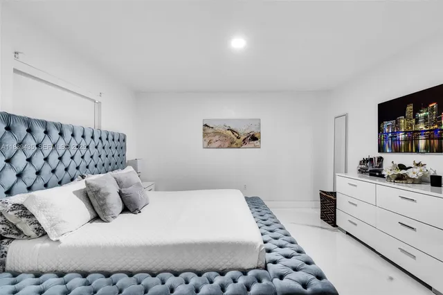 a bedroom with a bed and dresser