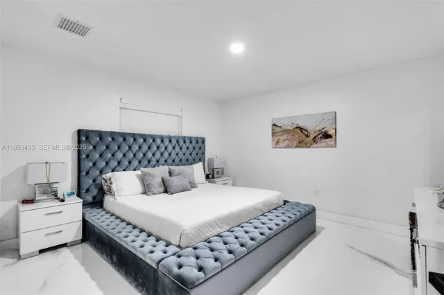 a bedroom with a large bed and a couch