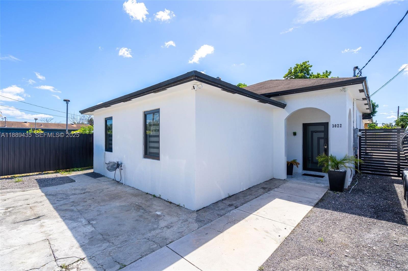 3022 Northwest 95th Street Miami, FL 33147 - Photo 2 of 47 a view of a house with potted plants