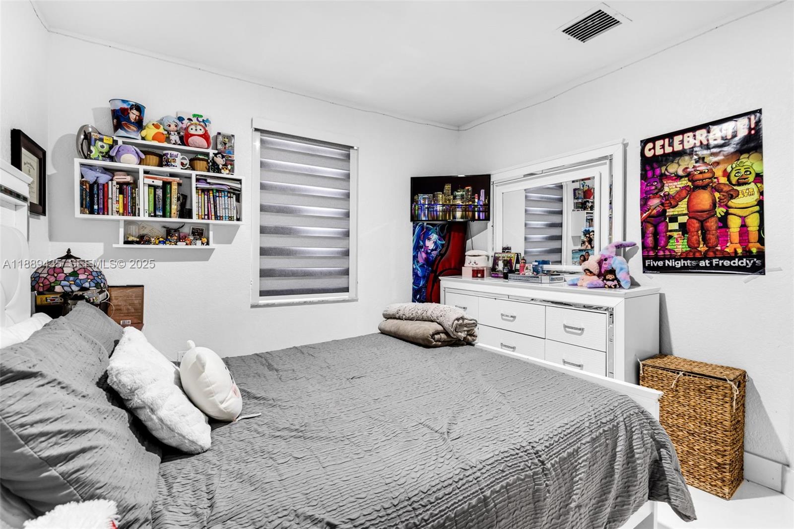 3022 Northwest 95th Street Miami, FL 33147 - Photo 24 of 47 a bedroom with a bed and a book shelf