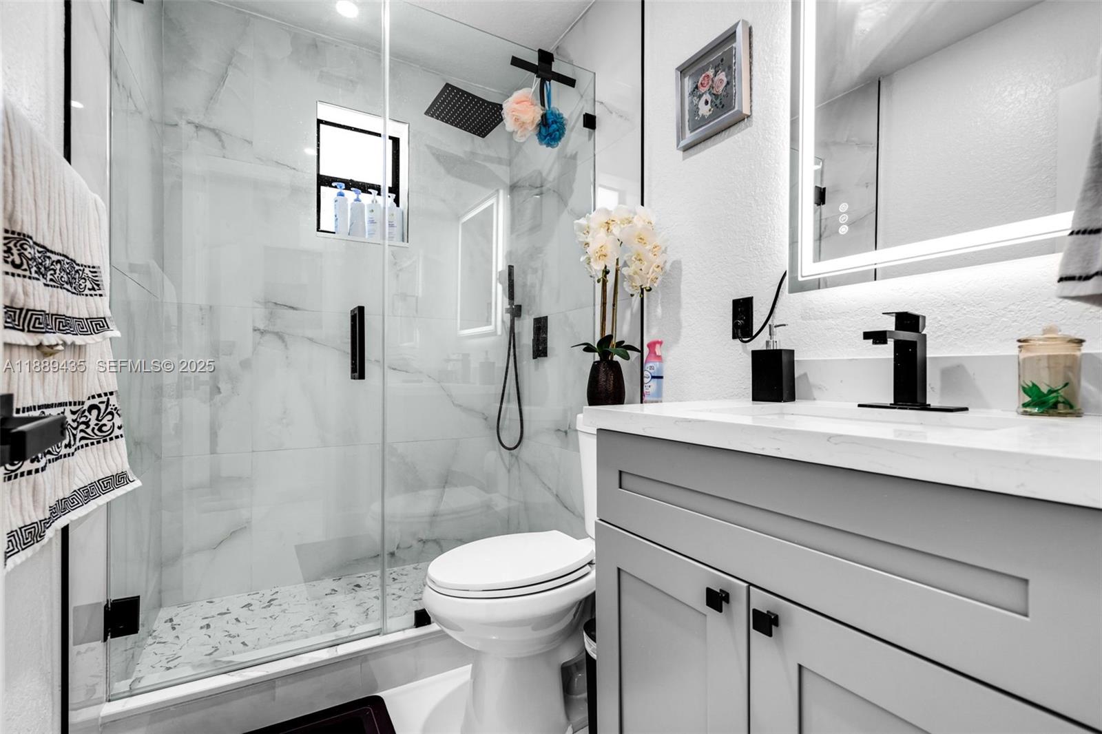 3022 Northwest 95th Street Miami, FL 33147 - Photo 26 of 47 a bathroom with a sink a toilet and shower