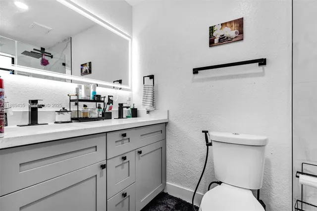 a bathroom with a toilet sink and shower