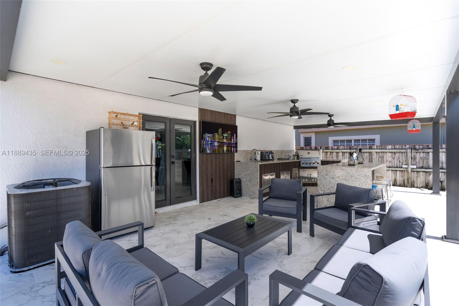 3022 Northwest 95th Street Miami, FL 33147 - Photo 33 of 47 a living room with furniture a refrigerator and kitchen view