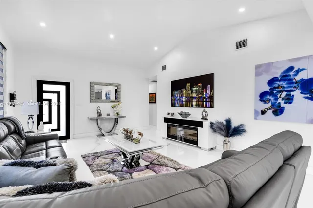 a living room with furniture fireplace and flat screen tv