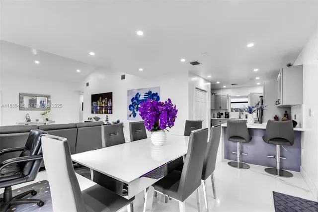 a large kitchen with a table and chairs