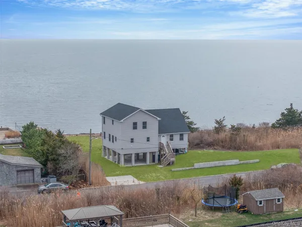 a aerial view of a house with a yard and a garage