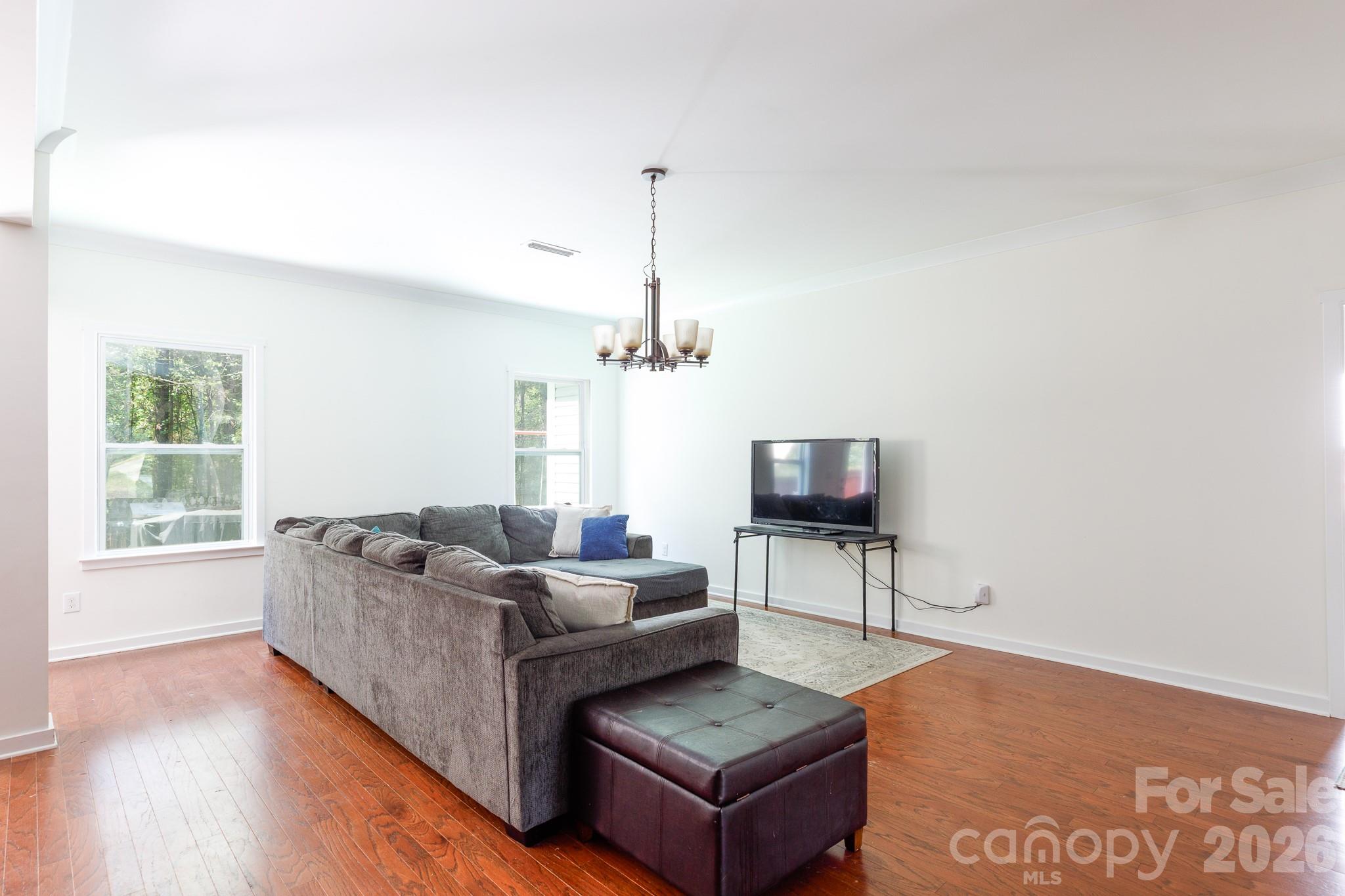 3121 Crosswind Drive Fort Mill, SC 29707 - Photo 12 of 31 a living room with furniture a flat screen tv and a large window