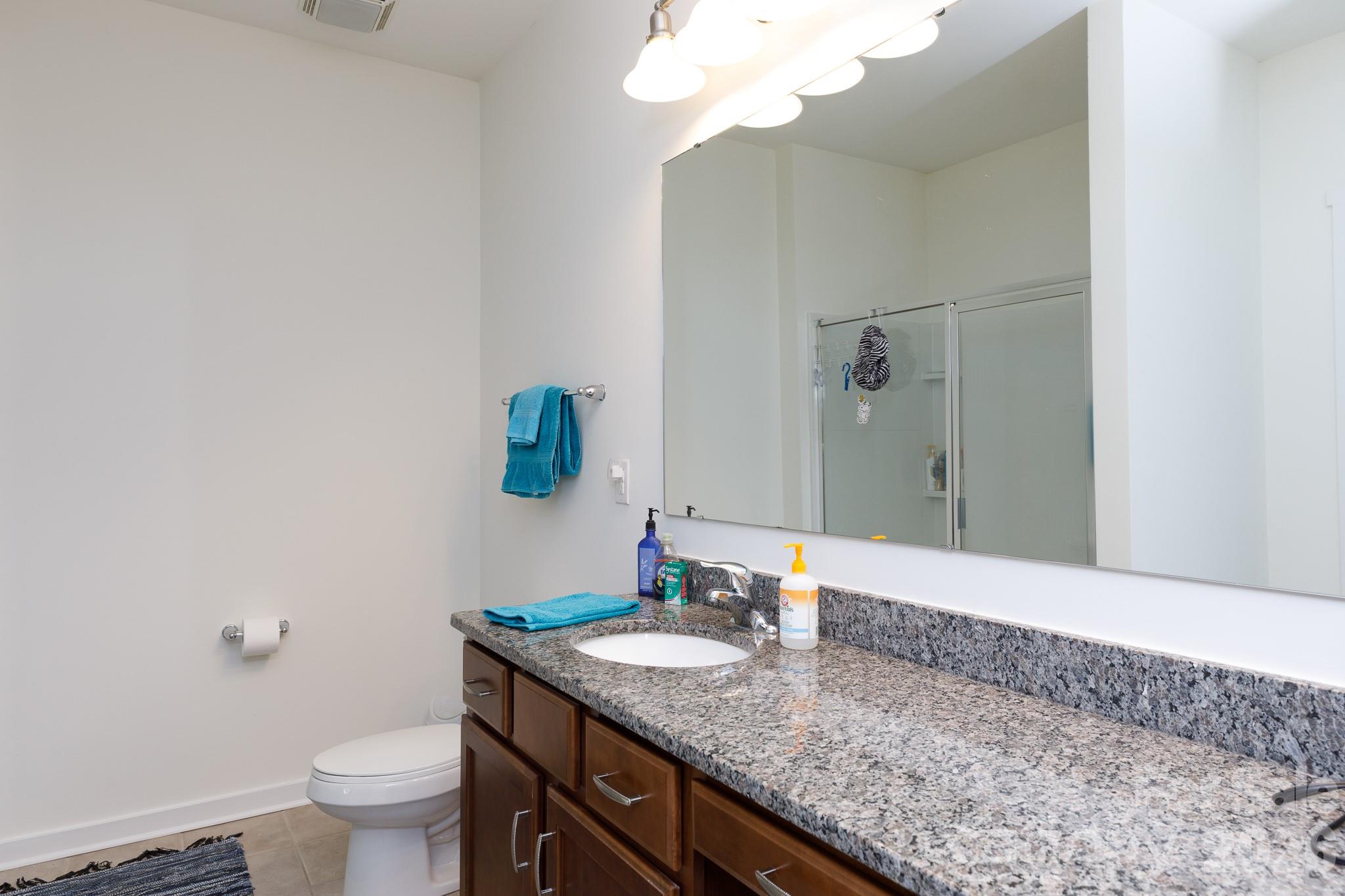 3121 Crosswind Drive Fort Mill, SC 29707 - Photo 14 of 31 a bathroom with a granite countertop sink a toilet and a mirror
