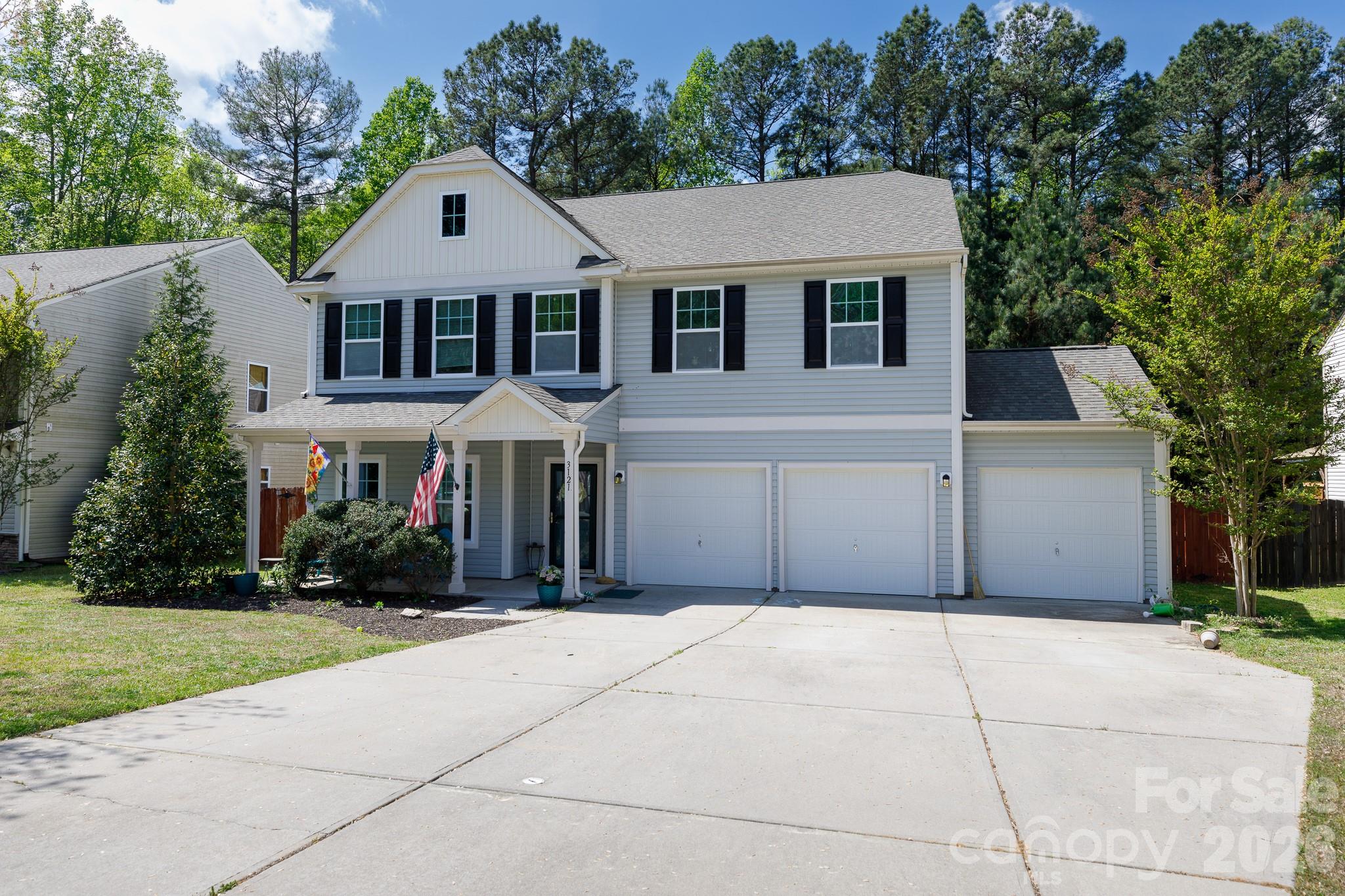 3121 Crosswind Drive Fort Mill, SC 29707 - Photo 2 of 31 a front view of a house with a yard and garage