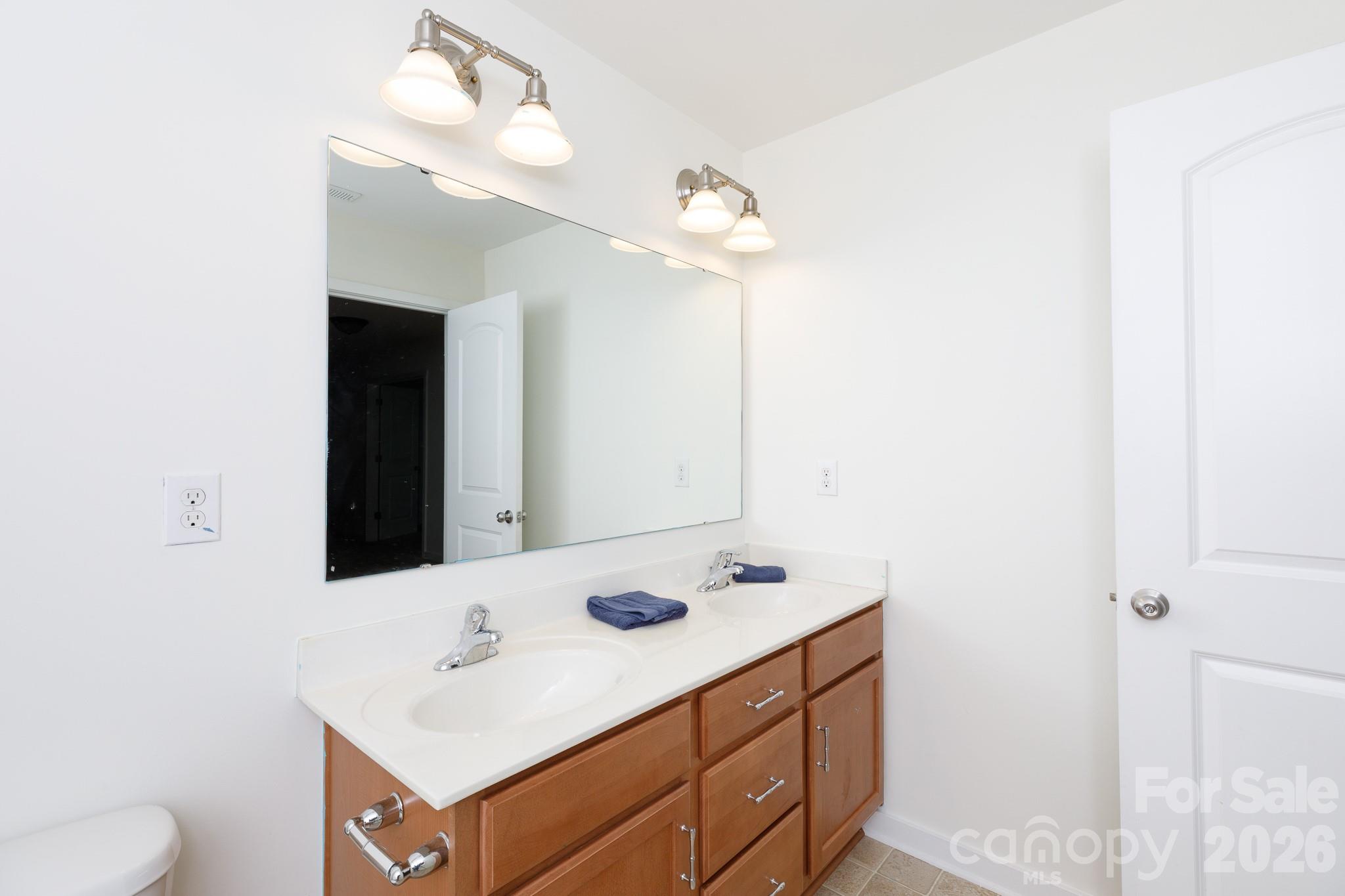3121 Crosswind Drive Fort Mill, SC 29707 - Photo 23 of 31 a bathroom with a sink vanity and a mirror