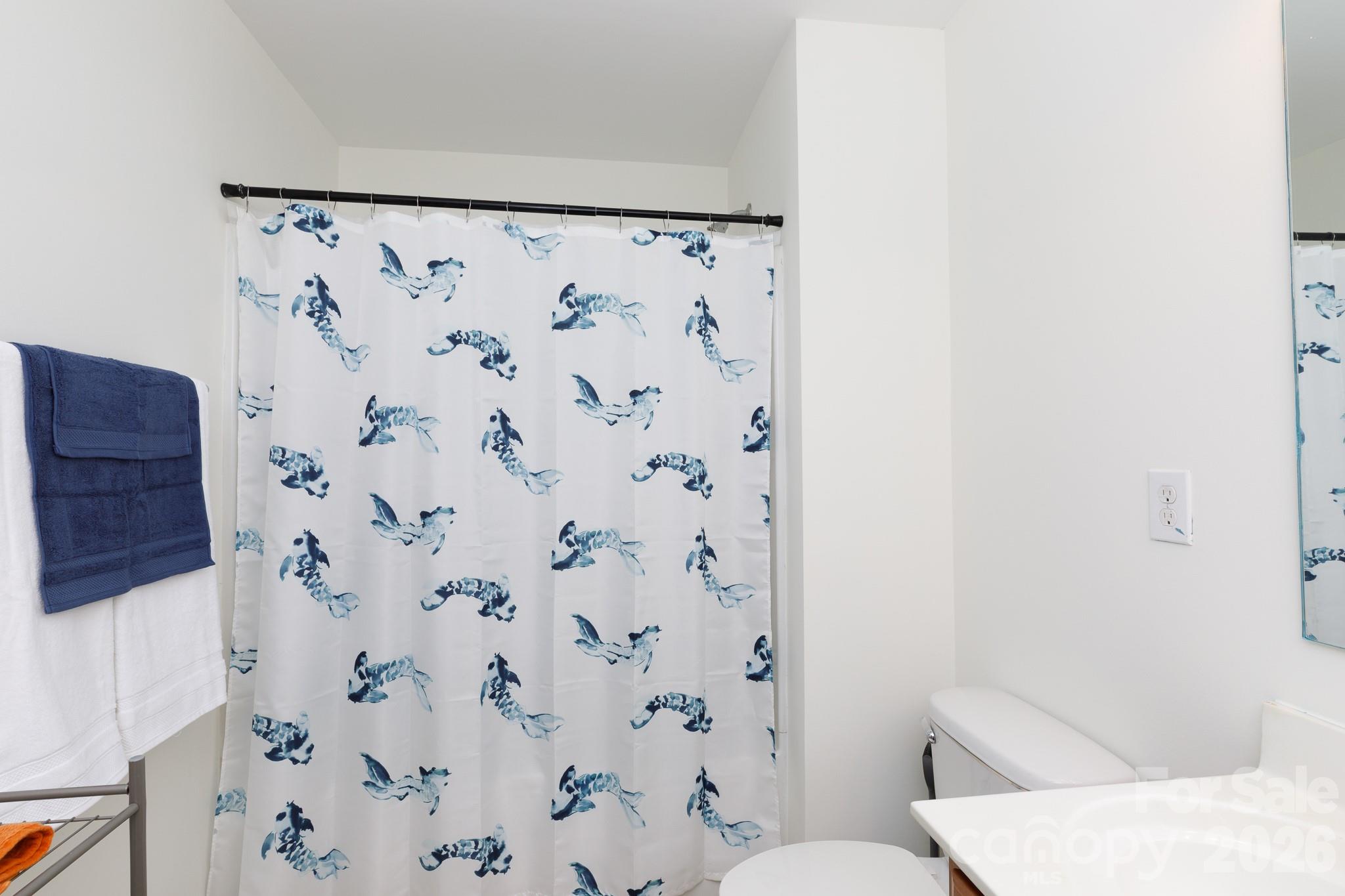 3121 Crosswind Drive Fort Mill, SC 29707 - Photo 24 of 31 a white toilet sitting next to a shower curtain