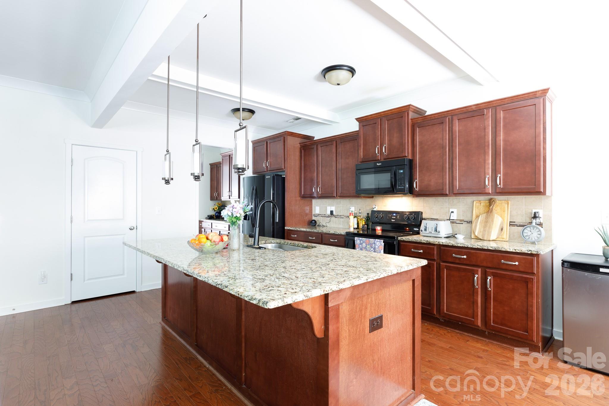 3121 Crosswind Drive Fort Mill, SC 29707 - Photo 7 of 31 a kitchen with stainless steel appliances granite countertop a sink a stove and a refrigerator