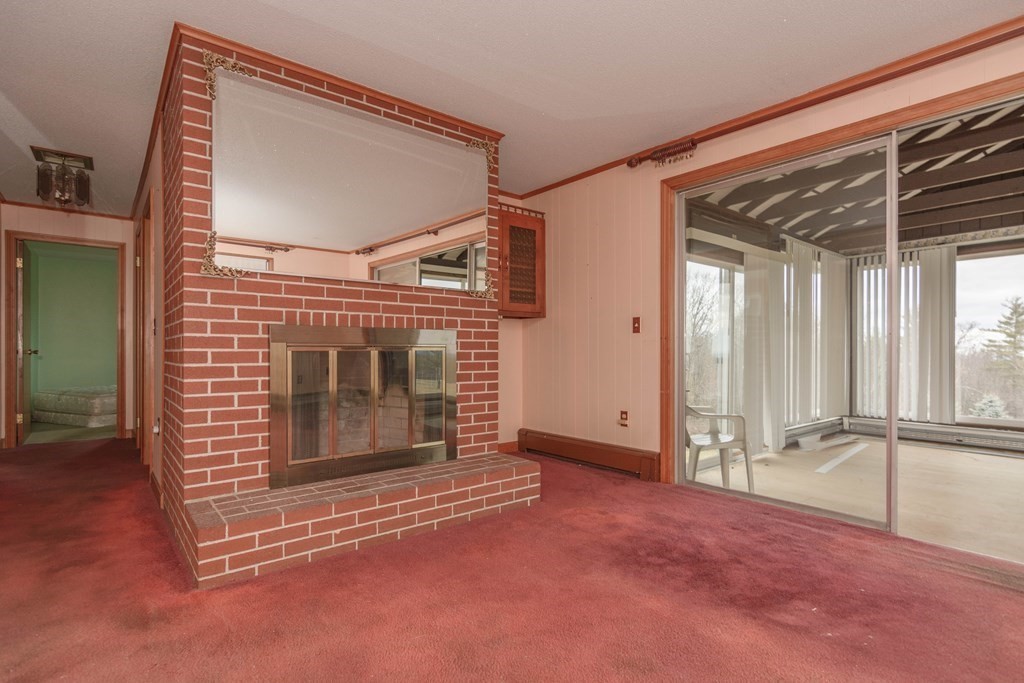 44 Telephone Road Ashby, MA 01431 - Photo 20 of 28 a view of an empty room with a fireplace and a window