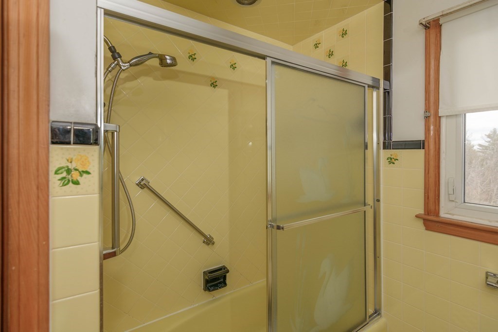 44 Telephone Road Ashby, MA 01431 - Photo 24 of 28 a bathroom with a glass shower door