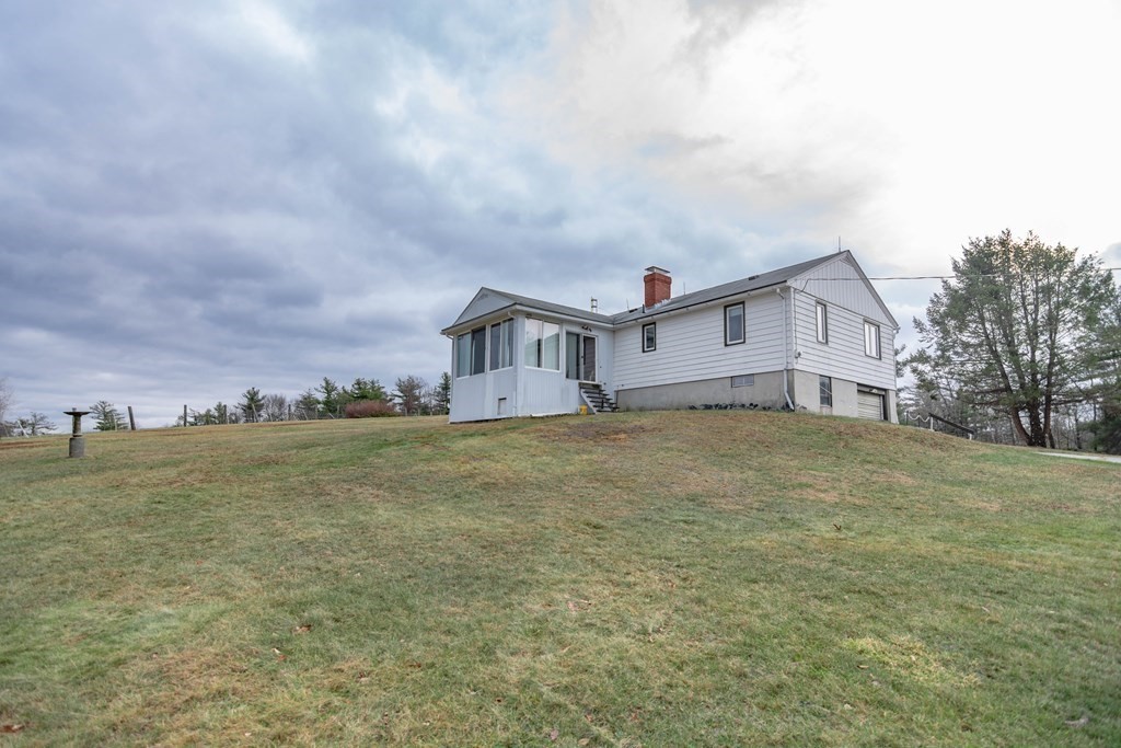 44 Telephone Road Ashby, MA 01431 - Photo 6 of 28 a view of a house with a yard and sitting area