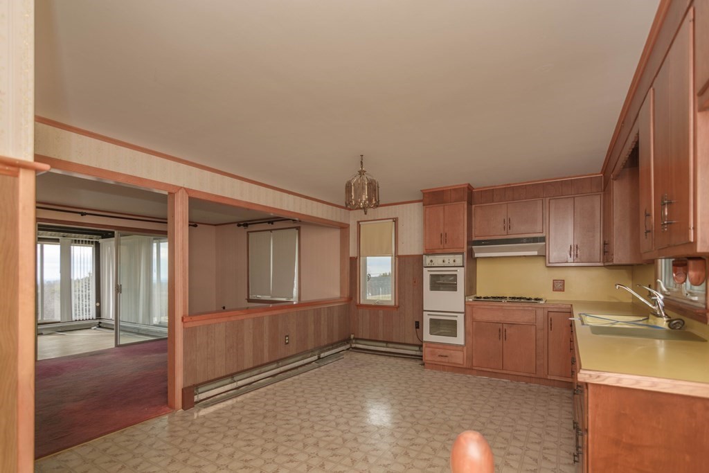 44 Telephone Road Ashby, MA 01431 - Photo 8 of 28 a view of a kitchen with refrigerator and cabinet