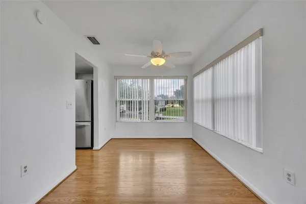 an empty room with wooden floor and a window