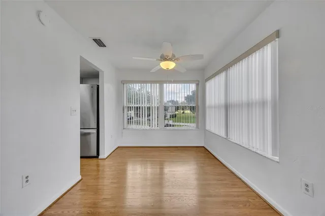 an empty room with wooden floor and a window