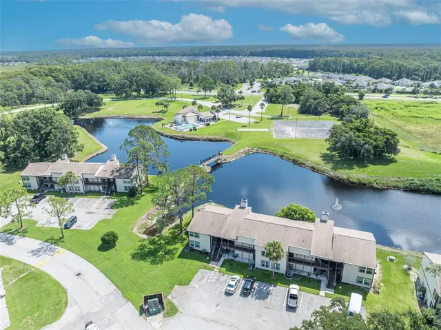 an aerial view of a house with garden space and mountain view in back