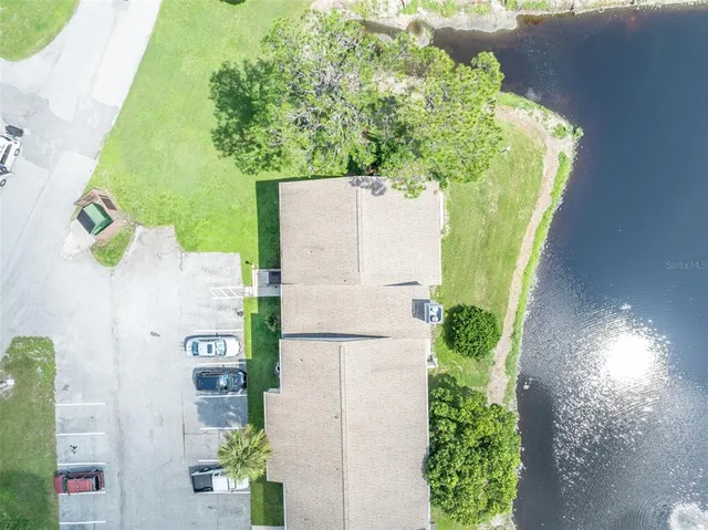 an aerial view of a residential house with a yard and garden