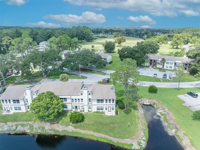 an aerial view of a house with yard swimming pool and outdoor seating