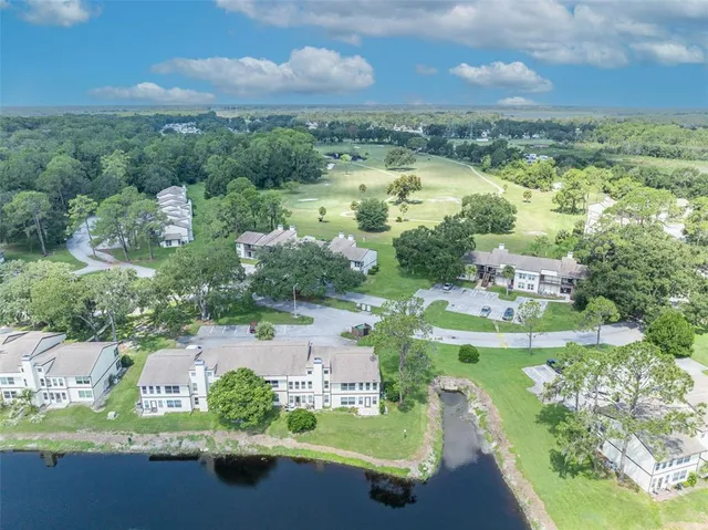 an aerial view of residential houses with outdoor space and street view