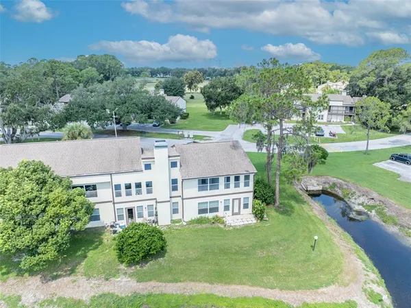 an aerial view of residential houses with outdoor space and swimming pool