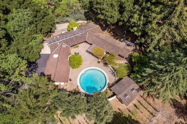 an aerial view of a house with a yard