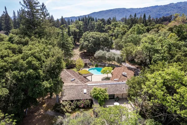 an aerial view of a house with a yard